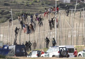 UN CENTENAR DE INMIGRANTES PERMANECEN ENCARAMADOS EN LA VALLA DE MELILLA